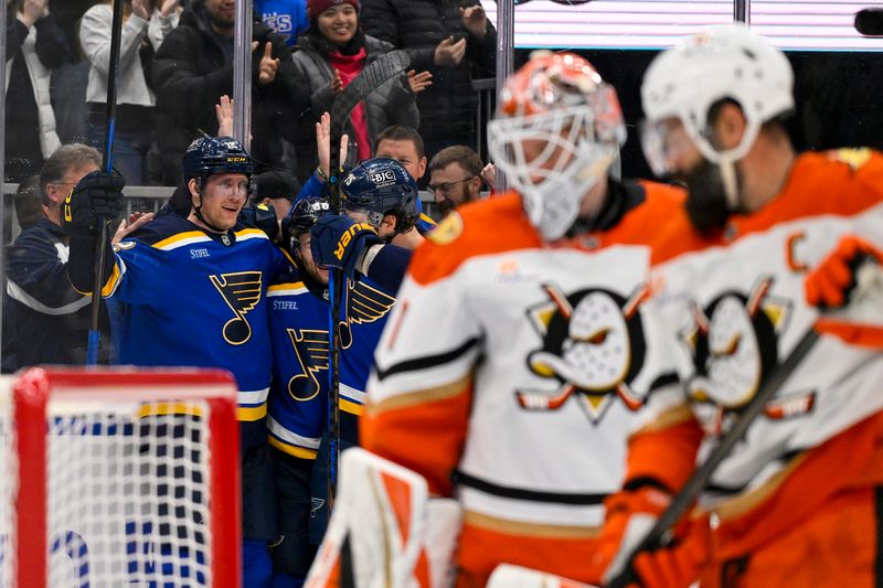 Mar 16, 2025; St. Louis, Missouri, USA;  St. Louis Blues center Radek Faksa (12) is congratulated by teammates after scoring against the Anaheim Ducks during the second period at Enterprise Center. Mandatory Credit: Jeff Curry-Imagn Images