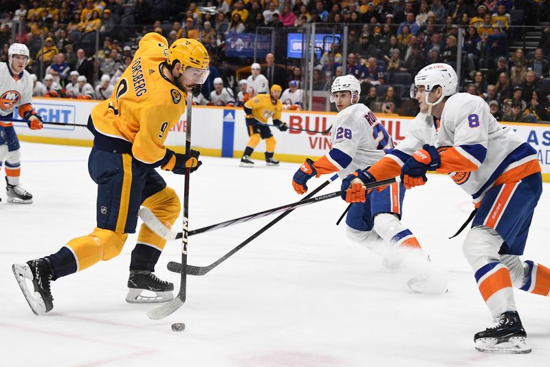 Jan 13, 2024; Nashville, Tennessee, USA; Nashville Predators left wing Filip Forsberg (9) tries to handles the puck past New York Islanders defenseman Noah Dobson (8) during the first period at Bridgestone Arena. Mandatory Credit: Christopher Hanewinckel-USA TODAY Sports