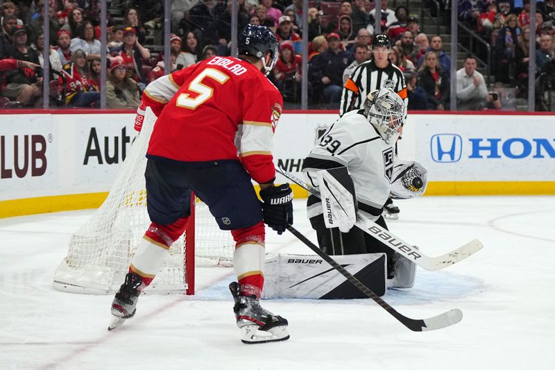 Jan 11, 2024; Sunrise, Florida, USA; Los Angeles Kings goaltender Cam Talbot (39) makes a save in front of Florida Panthers defenseman Aaron Ekblad (5) during the second period at Amerant Bank Arena. Mandatory Credit: Jasen Vinlove-USA TODAY Sports