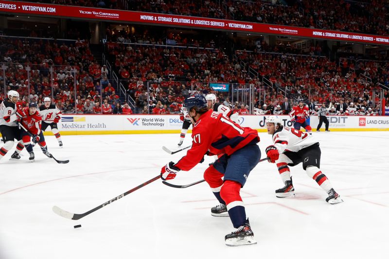 Oct 12, 2024; Washington, District of Columbia, USA; Washington Capitals center Dylan Strome (17) skates with the puck as/New Jersey Devils center Dawson Mercer (91) chases in the third period at Capital One Arena. Mandatory Credit: Geoff Burke-Imagn Images