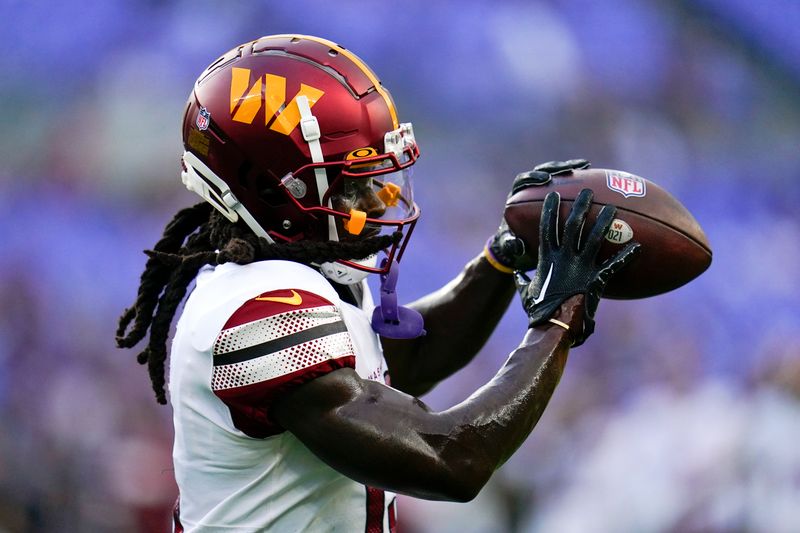 Washington Commanders wide receiver Marken Michel warms up before a preseason NFL football game against the Baltimore Ravens, Saturday, Aug. 27, 2022, in Baltimore. (AP Photo/Julio Cortez)