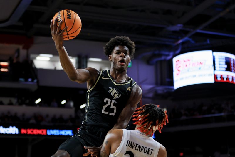 Feb 4, 2023; Cincinnati, Ohio, USA;  UCF Knights forward Taylor Hendricks (25) drives to the basket as he is fouled by Cincinnati Bearcats guard Jeremiah Davenport (24) in the second half at Fifth Third Arena. Mandatory Credit: Aaron Doster-USA TODAY Sports