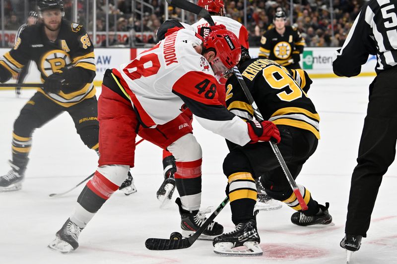 Nov 1, 2025; Boston, Massachusetts, USA; Carolina Hurricanes left wing Jordan Martinook (48) battles Boston Bruins center Marat Khusnutdinov (92) in the face-off circle during the first period at TD Garden. Mandatory Credit: Eric Canha-Imagn Images
