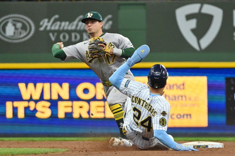 Apr 20, 2025; Milwaukee, Wisconsin, USA; Athletics third baseman Luis Urias (17) completes a double play after forcing out Milwaukee Brewers designated hitter William Contreras (24) during the sixth inning at American Family Field. Mandatory Credit: Patrick Gorski-Imagn Images