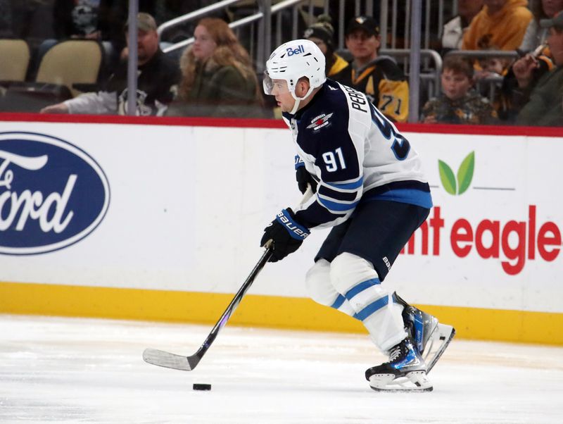 Nov 22, 2024; Pittsburgh, Pennsylvania, USA; Winnipeg Jets center Cole Perfetti (91) moves the puck against the Pittsburgh Penguins during the third period at PPG Paints Arena. Mandatory Credit: Charles LeClaire-Imagn Images