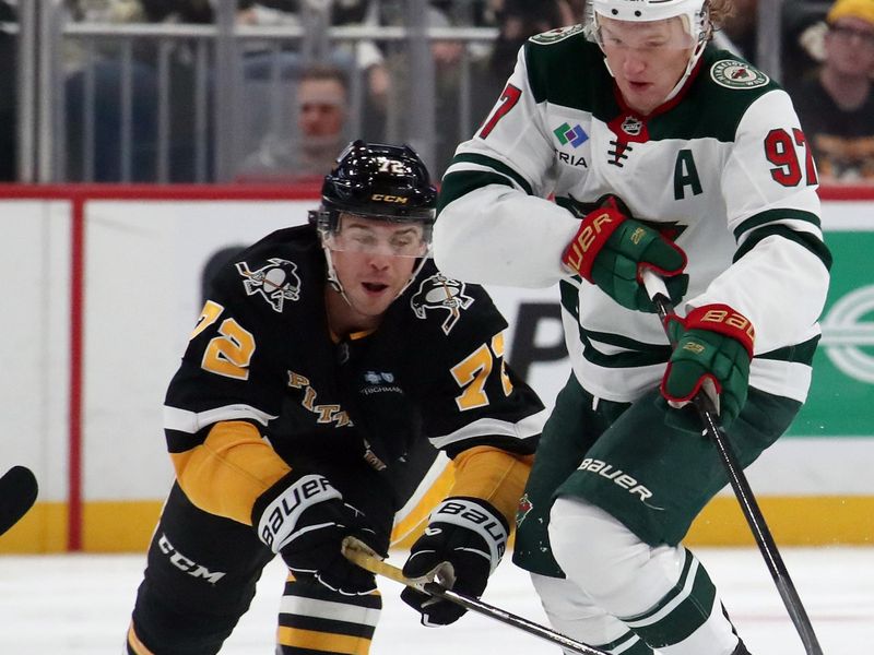 Oct 29, 2024; Pittsburgh, Pennsylvania, USA; Minnesota Wild left wing Kirill Kaprizov (97) moves the puck against Pittsburgh Penguins left wing Anthony Beauvillier (72) during the second period at PPG Paints Arena. Mandatory Credit: Charles LeClaire-Imagn Images