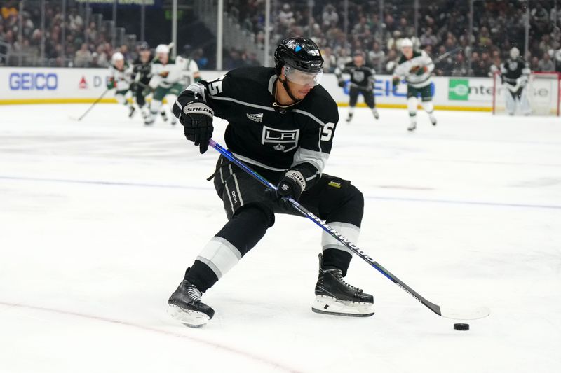 Apr 15, 2024; Los Angeles, California, USA; LA Kings right wing Quinton Byfield (55) skates with the puck against the Minnesota Wild in the second period at Crypto.com Arena. Mandatory Credit: Kirby Lee-USA TODAY Sports