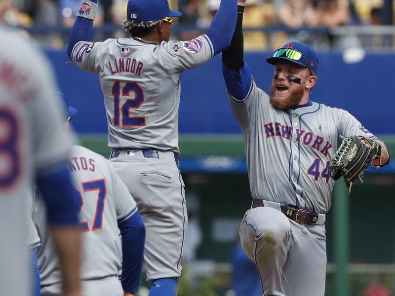 Jul 7, 2024; Pittsburgh, Pennsylvania, USA;  New York Mets shortstop Francisco Lindor (12) and center fielder Harrison Bader (44) celebrate after defeating the Pittsburgh Pirates at PNC Park. The Mets won 3-2. Mandatory Credit: Charles LeClaire-USA TODAY Sports