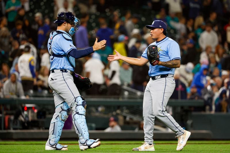 Aug 27, 2024; Seattle, Washington, USA; Tampa Bay Rays relief pitcher Manuel Rodriguez (39) shakes hands with catcher Alex Jackson (28) following the final out of the ninth inning against the Seattle Mariners at T-Mobile Park. Mandatory Credit: Joe Nicholson-USA TODAY Sports