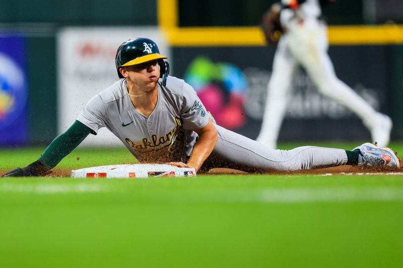 Aug 28, 2024; Cincinnati, Ohio, USA; Oakland Athletics second baseman Zack Gelof (20) steals third in the seventh inning against the Cincinnati Reds at Great American Ball Park. Mandatory Credit: Katie Stratman-USA TODAY Sports