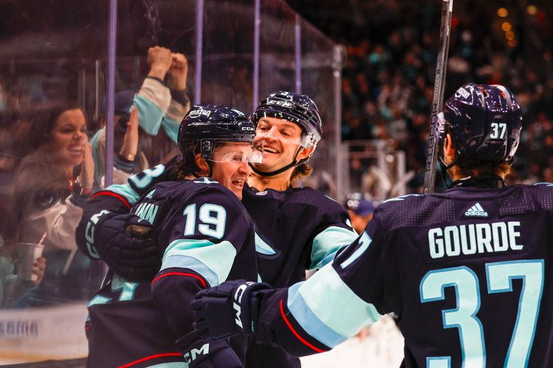 Feb 19, 2024; Seattle, Washington, USA; Seattle Kraken left wing Jared McCann (19) celebrates with defenseman Will Borgen (3) after scoring a goal against the Detroit Red Wings during the second period at Climate Pledge Arena. Mandatory Credit: Joe Nicholson-USA TODAY Sports