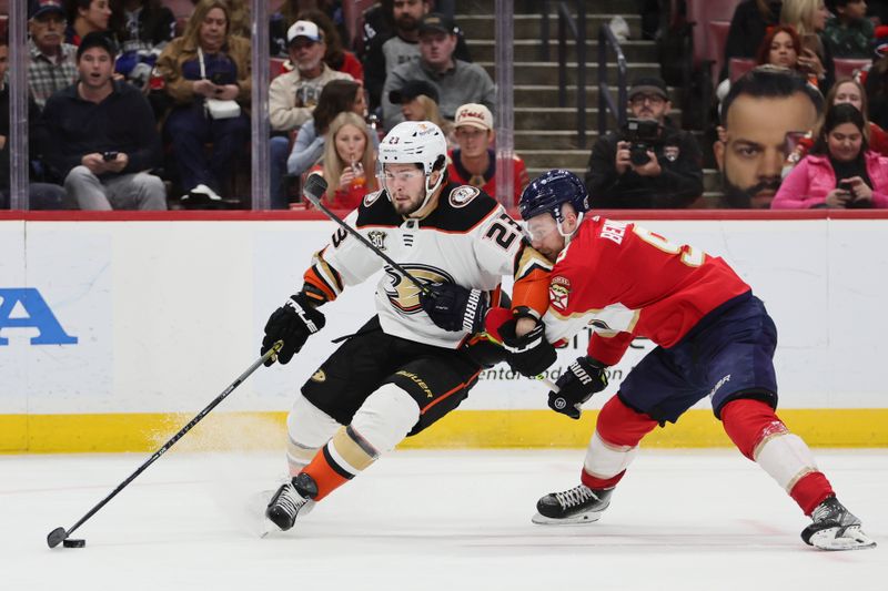 Jan 15, 2024; Sunrise, Florida, USA; Anaheim Ducks center Mason McTavish (23) protects the puck from Florida Panthers center Sam Bennett (9) during the third period at Amerant Bank Arena. Mandatory Credit: Sam Navarro-USA TODAY Sports