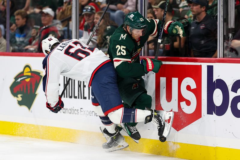 Oct 10, 2024; Saint Paul, Minnesota, USA; Columbus Blue Jackets right wing Kevin Labanc (62) and Minnesota Wild defenseman Jonas Brodin (25) compete for the puck during the third period at Xcel Energy Center. Mandatory Credit: Matt Krohn-Imagn Images