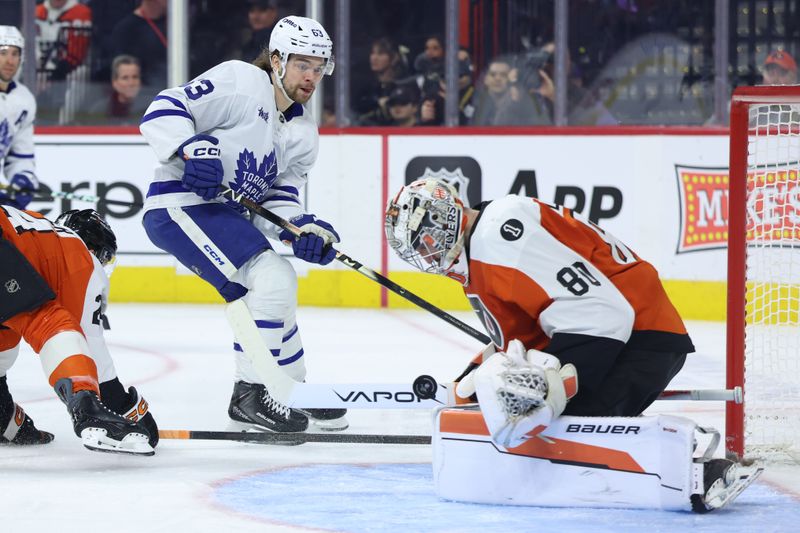 Jan 8, 2026; Philadelphia, Pennsylvania, USA; Philadelphia Flyers goaltender Dan Vladar (80) makes a save on Toronto Maple Leafs left wing Matias MacCelli (63) during the second period at Xfinity Mobile Arena. Mandatory Credit: Bill Streicher-Imagn Images