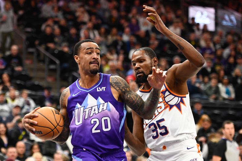 SALT LAKE CITY, UTAH - DECEMBER 13: John Collins #20 of the Utah Jazz handles the ball as Kevin Durant #35 of the Phoenix Suns defends during the first half of a game at Delta Center on December 13, 2024 in Salt Lake City, Utah.  NOTE TO USER: User expressly acknowledges and agrees that, by downloading and or using this photograph, User is consenting to the terms and conditions of the Getty Images License Agreement. (Photo by Alex Goodlett/Getty Images)