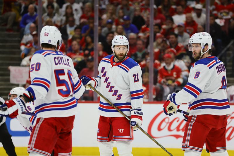 May 26, 2024; Sunrise, Florida, USA; New York Rangers center Barclay Goodrow (21) talks to defenseman Jacob Trouba (8) and left wing Will Cuylle (50) during the first period in game three of the Eastern Conference Final of the 2024 Stanley Cup Playoffs at Amerant Bank Arena. Mandatory Credit: Sam Navarro-USA TODAY Sports