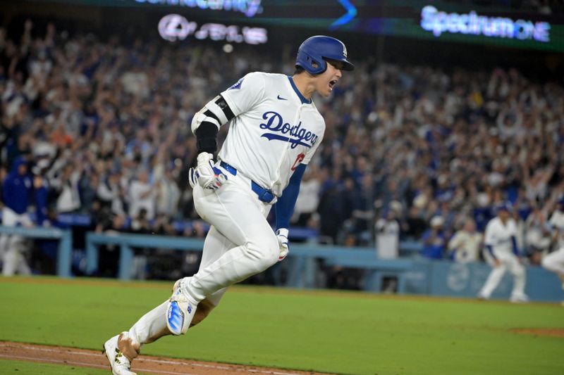 Sep 26, 2024; Los Angeles, California, USA;  Los Angeles Dodgers designated hitter Shohei Ohtani (17) celebrates as he runs to first after he singled in the go ahead run in the seventh inning against the San Diego Padres at Dodger Stadium. Mandatory Credit: Jayne Kamin-Oncea-Imagn Images