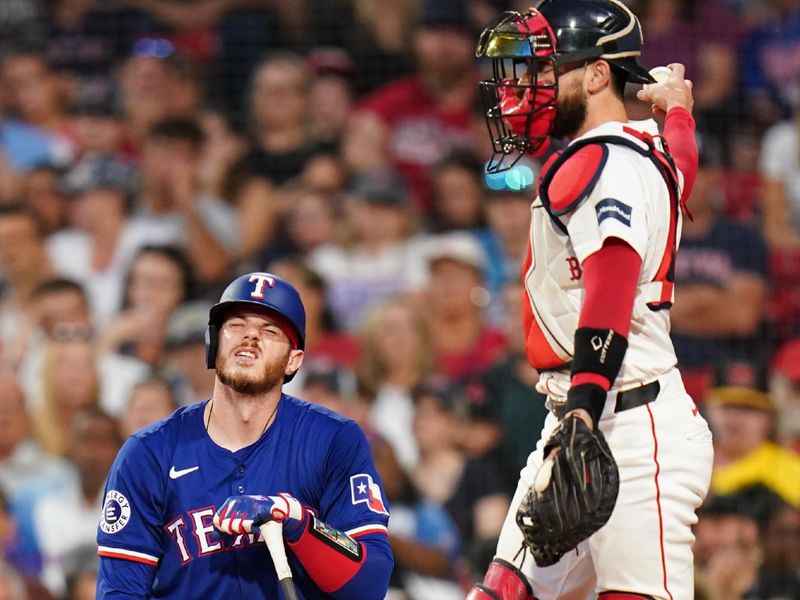 Aug 12, 2024; Boston, Massachusetts, USA; Texas Rangers catcher Jonah Heim (28) is hit by a pitch against the Boston Red Sox in the third inning at Fenway Park. Mandatory Credit: David Butler II-USA TODAY Sports