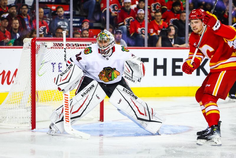 Oct 15, 2024; Calgary, Alberta, CAN; Chicago Blackhawks goaltender Petr Mrazek (34) guards his net against the Calgary Flames during the second period at Scotiabank Saddledome. Mandatory Credit: Sergei Belski-Imagn Images