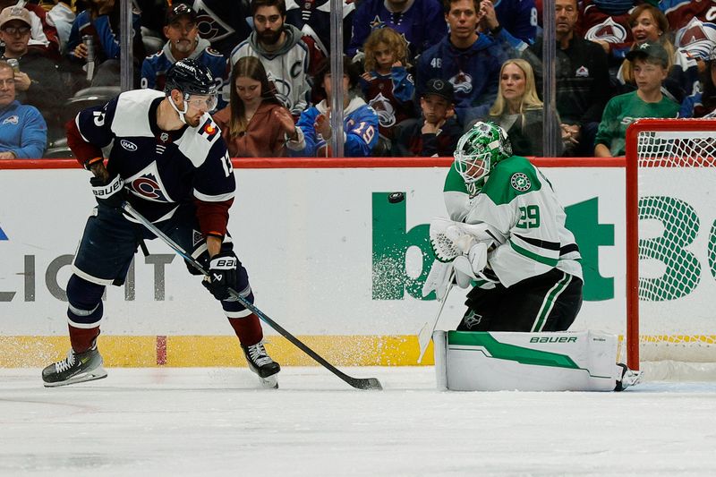 Oct 11, 2025; Denver, Colorado, USA; Dallas Stars goaltender Jake Oettinger (29) makes a save as Colorado Avalanche right wing Valeri Nichushkin (13) defends in the third period at Ball Arena. Mandatory Credit: Isaiah J. Downing-Imagn Images