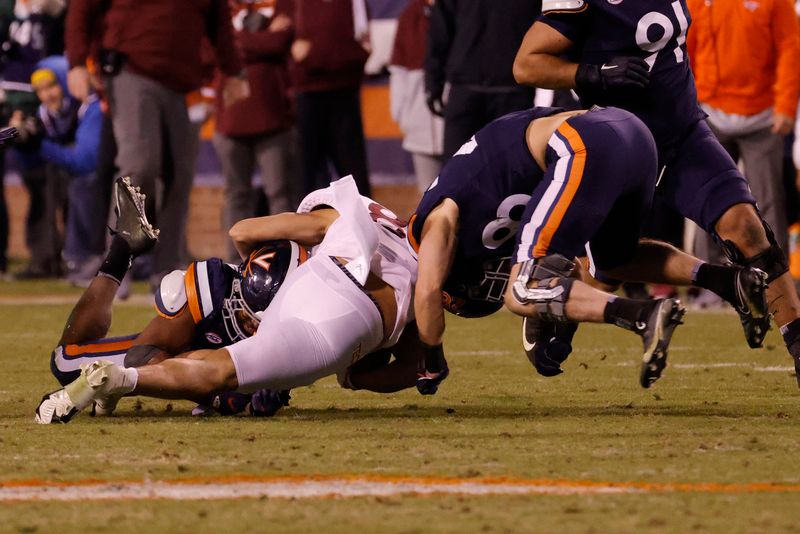 Nov 27, 2021; Charlottesville, Virginia, USA; Virginia Cavaliers inside linebacker Josh Ahern (28) tackles Virginia Tech Hokies wide receiver Kaleb Smith (80) during the fourth quarter at Scott Stadium. Ahem was called for targeting on the play. Mandatory Credit: Geoff Burke-USA TODAY Sports