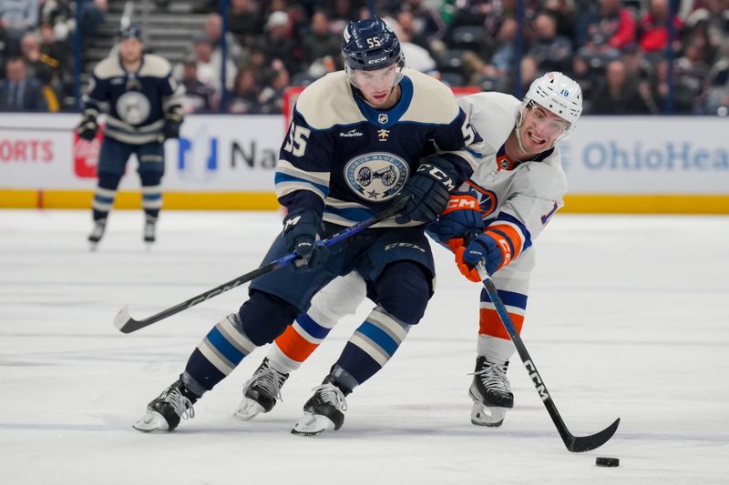 Apr 4, 2024; Columbus, Ohio, USA;  Columbus Blue Jackets defenseman David Jiricek (55) battles for the puck against New York Islanders left wing Pierre Engvall (18) in the third period at Nationwide Arena. Mandatory Credit: Aaron Doster-USA TODAY Sports