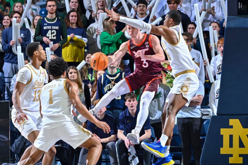 Feb 10, 2024; South Bend, Indiana, USA; Virginia Tech Hokies guard Sean Pedulla (3) passes the ball as Notre Dame Fighting Irish forward Kebba Njie (14) defends in the second half at the Purcell Pavilion. Mandatory Credit: Matt Cashore-USA TODAY Sports