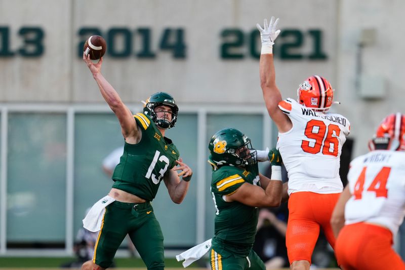 Oct 26, 2024; Waco, Texas, USA;  Baylor Bears quarterback Sawyer Robertson (13) makes a pass against Oklahoma State Cowboys defensive end Kody Walterscheid (96) during the second half at McLane Stadium. Mandatory Credit: Chris Jones-Imagn Images