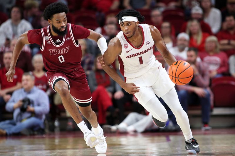 Nov 28, 2022; Fayetteville, Arkansas, USA; Troy Trojans guard Kieffer Punter (0) defends against Arkansas Razorbacks guard Ricky Council IV (1) during the second half at Bud Walton Arena. Arkansas won 74-61. Mandatory Credit: Nelson Chenault-USA TODAY Sports