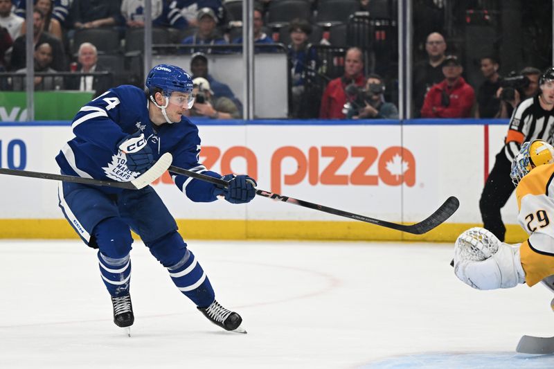 Oct 14, 2025; Toronto, Ontario, CAN;  Toronto Maple Leafs forward Bobby McMann (74) shoots the puck against Nashville Predators goalie Justus Annunen (29) in the third period at Scotiabank Arena. Mandatory Credit: Dan Hamilton-Imagn Images