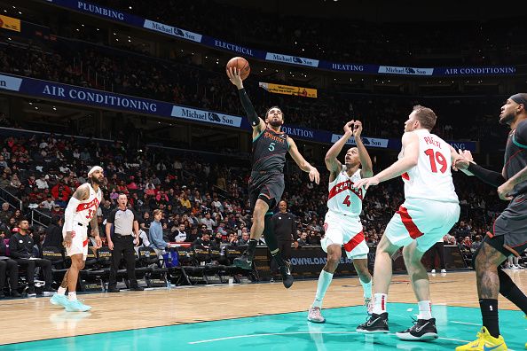 WASHINGTON, DC -? DECEMBER 27: Tyus Jones #5 of the Washington Wizards drives to the basket during the game against the Toronto Raptors on December 27, 2023 at Capital One Arena in Washington, DC. NOTE TO USER: User expressly acknowledges and agrees that, by downloading and or using this Photograph, user is consenting to the terms and conditions of the Getty Images License Agreement. Mandatory Copyright Notice: Copyright 2023 NBAE (Photo by Stephen Gosling/NBAE via Getty Images)