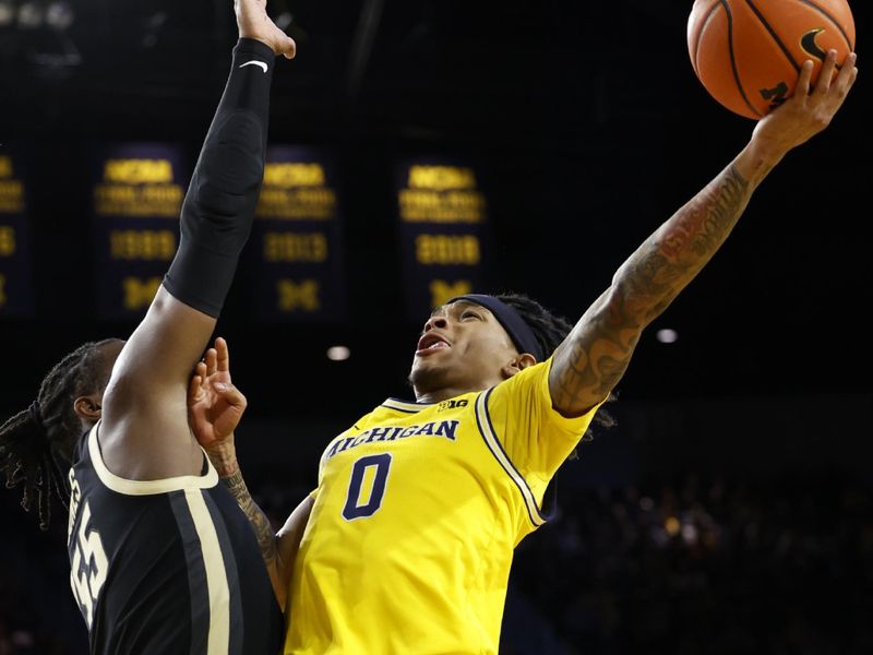 Feb 25, 2024; Ann Arbor, Michigan, USA;  Michigan Wolverines guard Dug McDaniel (0) shoots on Purdue Boilermakers guard Lance Jones (55) in the first half at Crisler Center. Mandatory Credit: Rick Osentoski-USA TODAY Sports