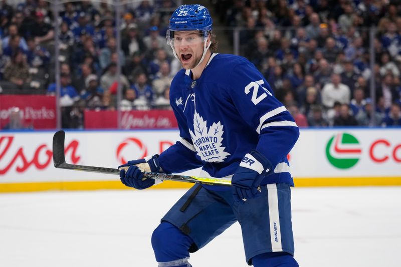 Mar 19, 2025; Toronto, Ontario, CAN; Toronto Maple Leafs defenceman Brandon Carlo (25) calls out a defence partner during the first period against the Colorado Avalanche at Scotiabank Arena. Mandatory Credit: John E. Sokolowski-Imagn Images