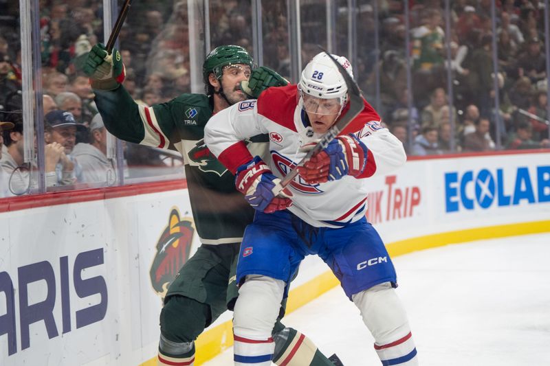 Nov 14, 2024; Saint Paul, Minnesota, USA; Montreal Canadiens center Christian Dvorak (28) checks Minnesota Wild defenseman Jake Middleton (5) in the first period at Xcel Energy Center. Mandatory Credit: Matt Blewett-Imagn Images