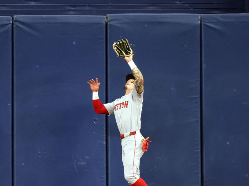 May 20, 2024; St. Petersburg, Florida, USA; Boston Red Sox outfielder Jarren Duran (16) catches a fly ball against the Tampa Bay Rays during the first inning at Tropicana Field. Mandatory Credit: Kim Klement Neitzel-USA TODAY Sports