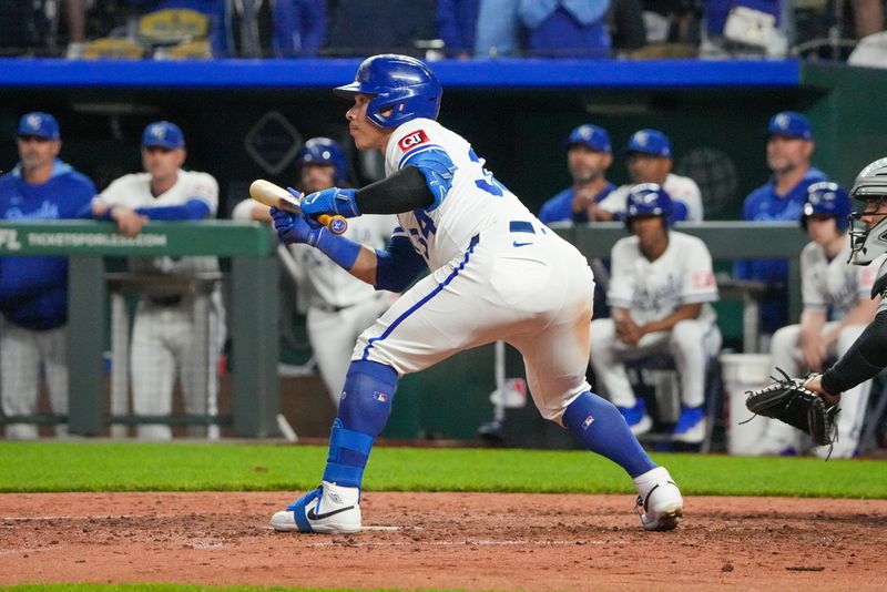 May 6, 2025; Kansas City, Missouri, USA; Kansas City Royals catcher Freddy Fermin (34) bunts for a single against the Chicago White Sox in the ninth inning at Kauffman Stadium. Mandatory Credit: Denny Medley-Imagn Images