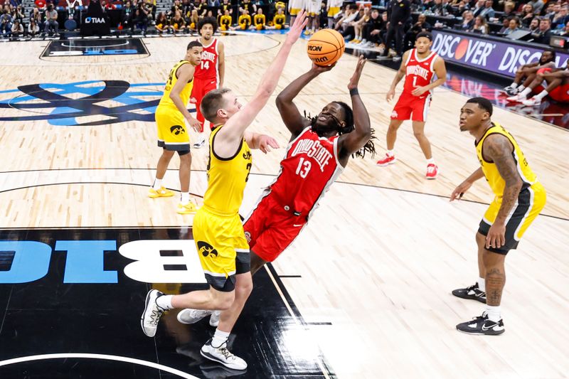 Mar 9, 2023; Chicago, IL, USA; Ohio State Buckeyes guard Isaac Likekele (13) shoots against Iowa Hawkeyes forward Payton Sandfort (20) during the second half at United Center. Mandatory Credit: Kamil Krzaczynski-USA TODAY Sports