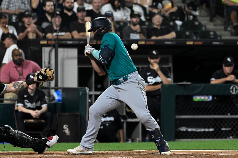 Aug 21, 2023; Chicago, Illinois, USA;  Seattle Mariners first baseman Ty France (23) is hit by a pitch thrown by Chicago White Sox relief pitcher Tanner Banks (57) during the sixth inning at Guaranteed Rate Field. Mandatory Credit: Matt Marton-USA TODAY Sports