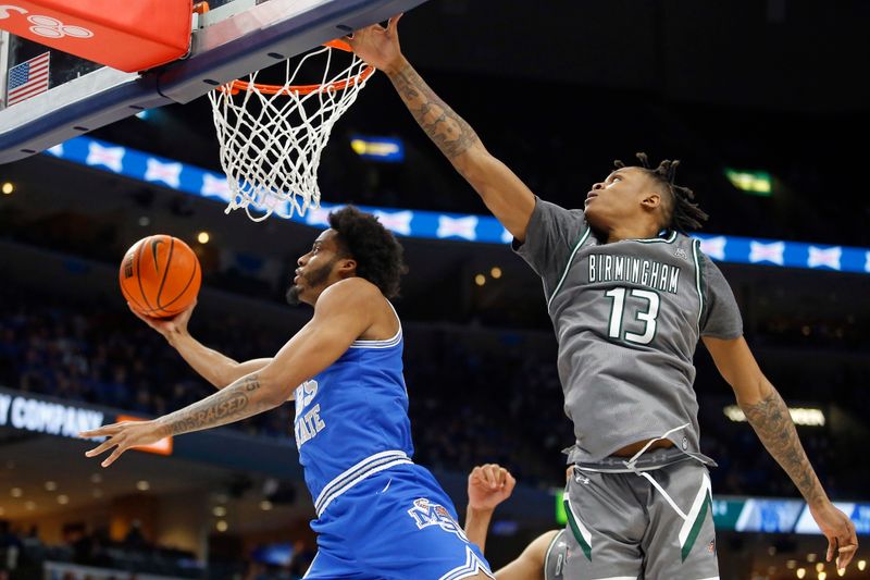 Mar 3, 2024; Memphis, Tennessee, USA; Memphis Tigers guard Jayden Hardaway (25) drives to the basket as UAB Blazers forward Christian Coleman (13) defends during the first half at FedExForum. Mandatory Credit: Petre Thomas-USA TODAY Sports