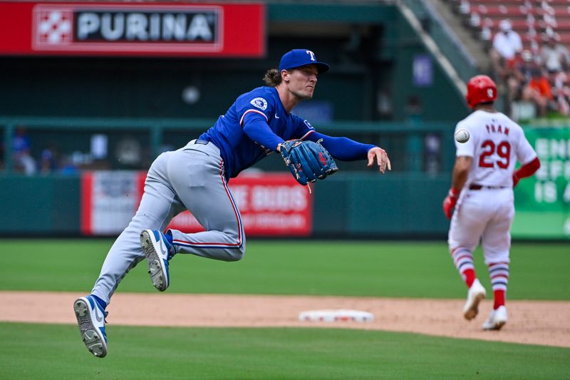 Jul 31, 2024; St. Louis, Missouri, USA;  Texas Rangers relief pitcher Jacob Latz (67) dives and throws to first but is unable to throw out St. Louis Cardinals center fielder Michael Siani (not pictured) during the seventh inning at Busch Stadium. Mandatory Credit: Jeff Curry-USA TODAY Sports