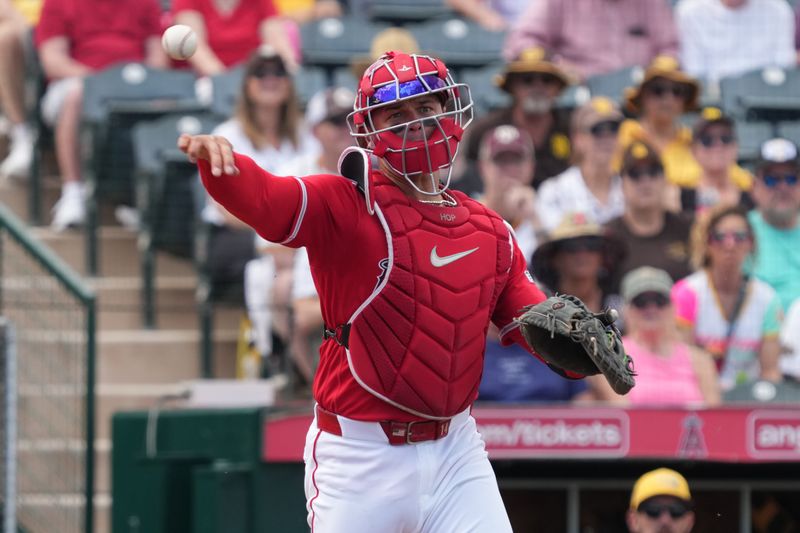 Mar 10, 2026; Tempe, Arizona, USA; Los Angeles Angels catcher Logan O'Hoppe (14) throws to first for an out against the San Diego Padres in the second inning at Tempe Diablo Stadium. Mandatory Credit: Rick Scuteri-Imagn Images