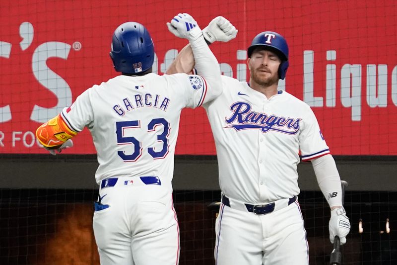 May 18, 2024; Arlington, Texas, USA; Texas Rangers right fielder Adolis Garcia (53) elbow bumps right fielder Robbie Grossman (4) after hitting a solo home run  during the sixth inning at Globe Life Field. Mandatory Credit: Raymond Carlin III-USA TODAY Sports