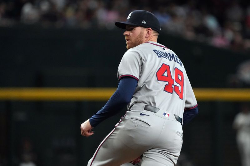 Apr 27, 2025; Phoenix, Arizona, USA; Atlanta Braves pitcher Aaron Bummer (49) throws against the Arizona Diamondbacks in the seventh inning at Chase Field. Mandatory Credit: Rick Scuteri-Imagn Images
