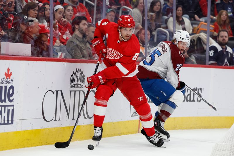 Feb 22, 2024; Detroit, Michigan, USA;  Detroit Red Wings defenseman Ben Chiarot (8) skates with the puck chased by Colorado Avalanche right wing Logan O   Connor (25) in the first period at Little Caesars Arena. Mandatory Credit: Rick Osentoski-USA TODAY Sports