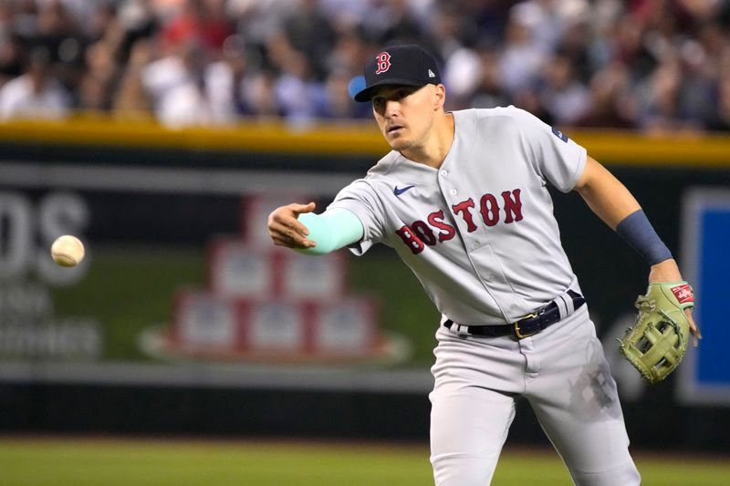 May 28, 2023; Phoenix, Arizona, USA; Boston Red Sox shortstop Enrique Hernandez (5) flips the ball back to second base against the Arizona Diamondbacks in the fifth inning at Chase Field. Mandatory Credit: Rick Scuteri-USA TODAY Sports