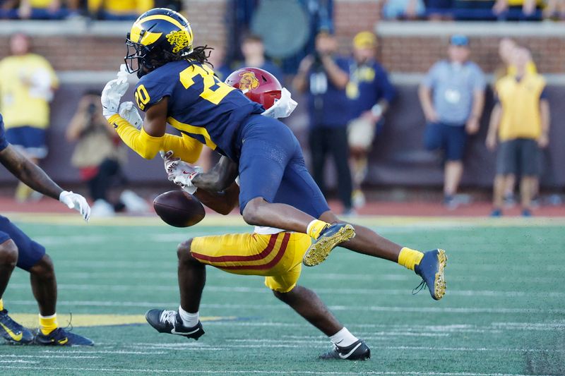 Sep 21, 2024; Ann Arbor, Michigan, USA;  Michigan Wolverines defensive back Jyaire Hill (20) breaks up a pass to USC Trojans wide receiver Zachariah Branch (1) in the second half at Michigan Stadium. Mandatory Credit: Rick Osentoski-Imagn Images