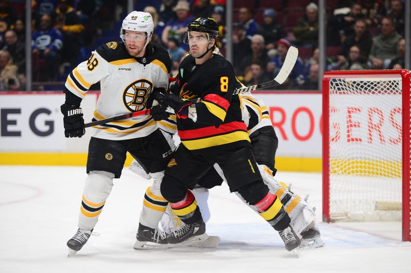 Feb 25, 2023; Vancouver, British Columbia, CAN; Boston Bruins defenseman Matt Grzelcyk (48) defends against Vancouver Canucks forward Conor Garland (8) during the first period at Rogers Arena. Mandatory Credit: Anne-Marie Sorvin-USA TODAY Sports