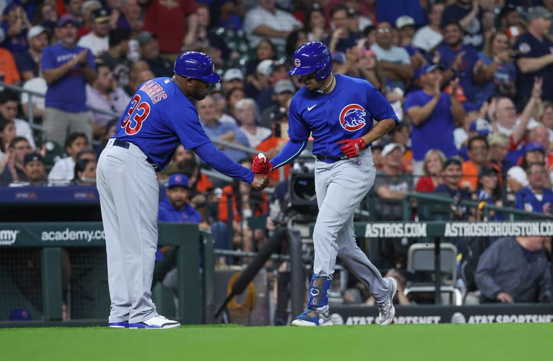 May 17, 2023; Houston, Texas, USA; Chicago Cubs center fielder Christopher Morel (5) celebrates with third base coach Willie Harris (33) after hitting a home run during the fourth inning against the Houston Astros at Minute Maid Park. Mandatory Credit: Troy Taormina-USA TODAY Sports