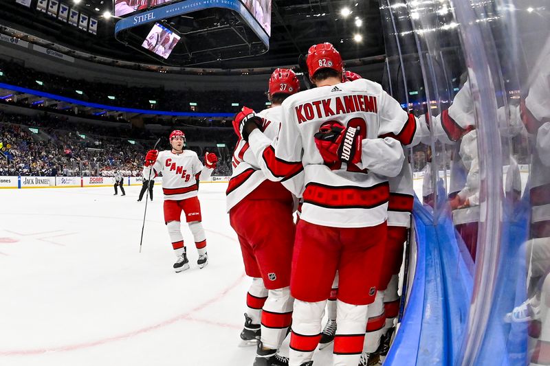 Apr 12, 2024; St. Louis, Missouri, USA;  Carolina Hurricanes left wing Jordan Martinook (48) is congratulated by teammates after scoring against the St. Louis Blues during the first period at Enterprise Center. Mandatory Credit: Jeff Curry-USA TODAY Sports