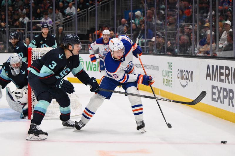 Mar 2, 2024; Seattle, Washington, USA; Seattle Kraken defenseman Will Borgen (3) and Edmonton Oilers left wing Zach Hyman (18) play the puck during the third period at Climate Pledge Arena. Mandatory Credit: Steven Bisig-USA TODAY Sports